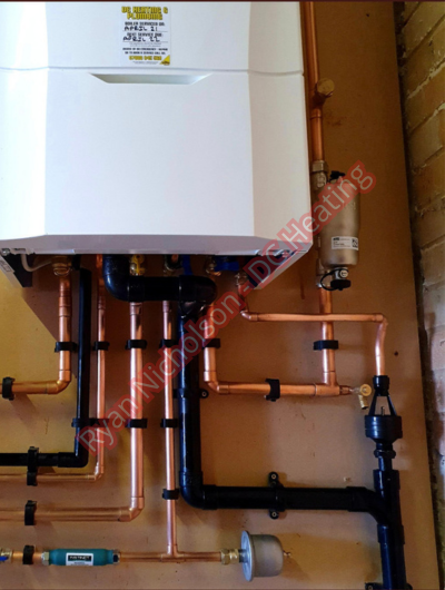 A picture of a typical boiler installation using a hotun dry trap tundish and a hotun detect alarm unit